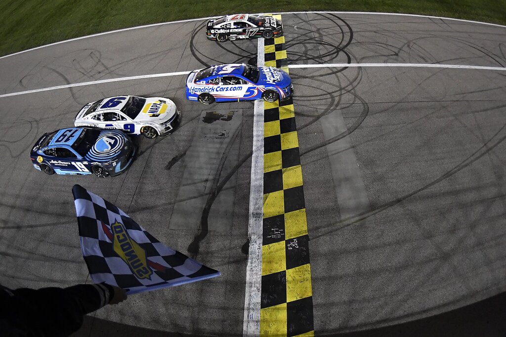 KANSAS CITY, KANSAS - MAY 05: Kyle Larson, driver of the #5 HendrickCars.com Chevrolet, takes the checkered flag over Chris Buescher, driver of the #17 Castrol Edge Ford, to win the NASCAR Cup Series AdventHealth 400 at Kansas Speedway on May 05, 2024 in Kansas City, Kansas. (Photo by Logan Riely/Getty Images)