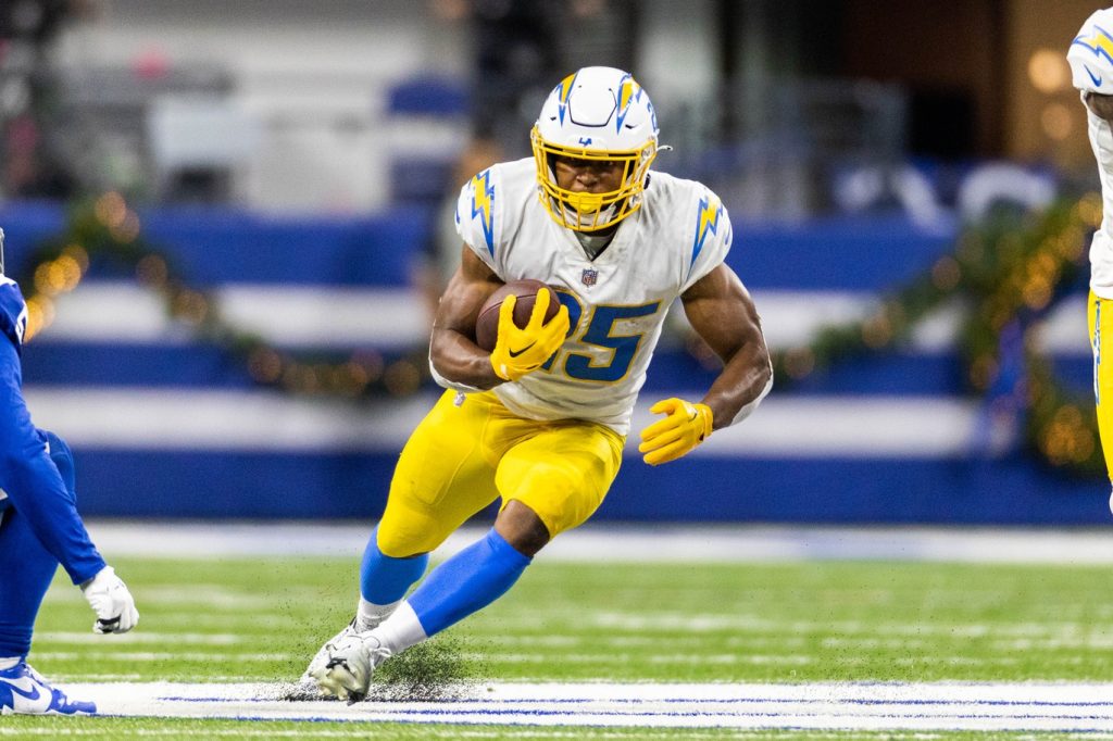 Los Angeles Chargers running back Isaiah Spiller tries to avoid