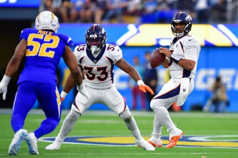 Javonte Williams and Russell Wilson of the Denver Broncos