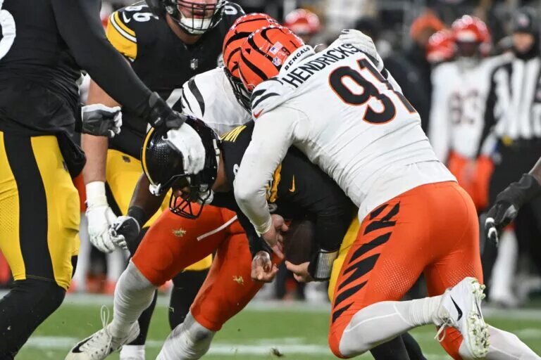 Jan 4, 2025; Pittsburgh, Pennsylvania, USA; Cincinnati Bengals defensive end Trey Hendrickson (91) sacks Pittsburgh Steelers quarterback Russell Wilson (3) during the first quarter at Acrisure Stadium. Mandatory Credit: Barry Reeger-Imagn Images
