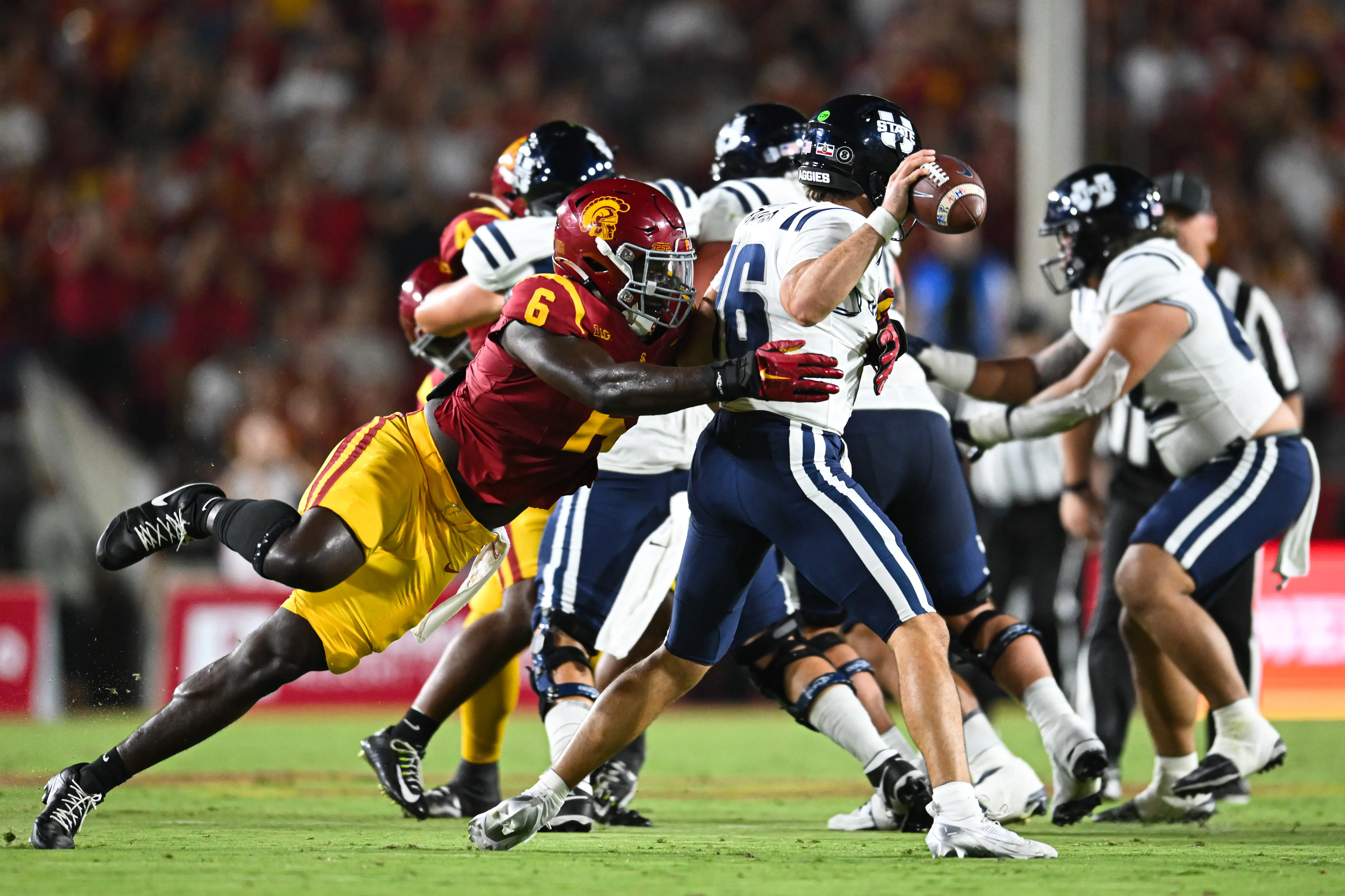 Sep 7, 2024; Los Angeles, California, USA; USC Trojans defensive end Anthony Lucas (6) attempts to sack Utah State Aggies quarterback Bryson Barnes (16) during the second quarter at United Airlines Field at Los Angeles Memorial Coliseum. 