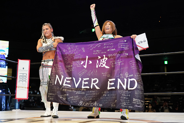 Konami and Giulia with the Never End banner