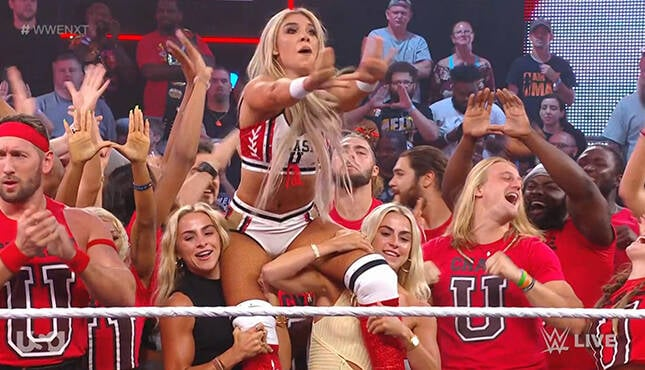 The Cavinder Twins hoisting up Thea Hail after her win on the June 6th edition of WWE NXT.