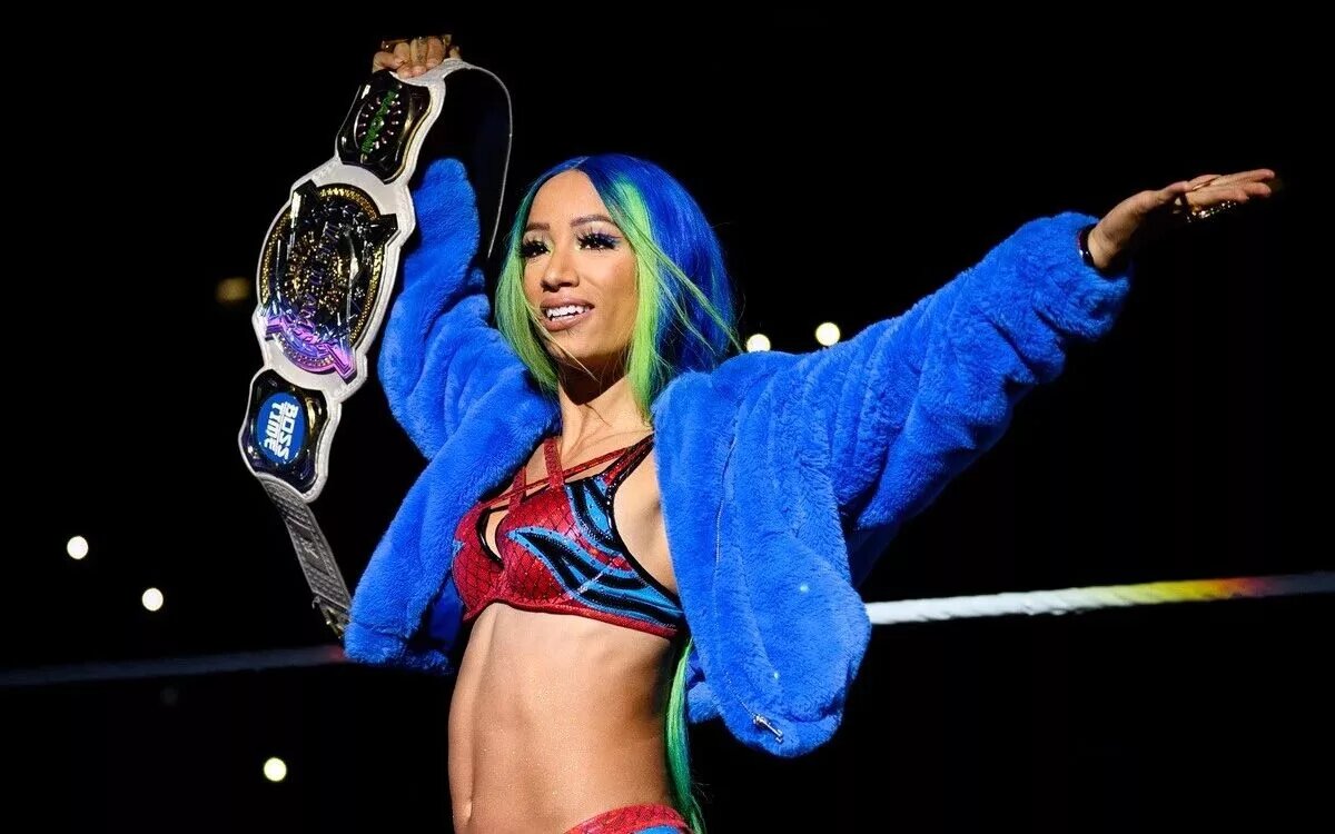 Sasha Banks holding the WWE Women's Tag Team Championship.