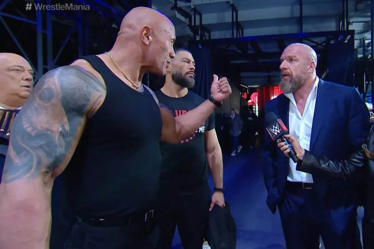 A photo of Triple H, Roman Reigns, and The Rock at the WWE WrestleMania XL press conference.