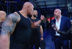 A photo of Triple H, Roman Reigns, and The Rock at the WWE WrestleMania XL press conference.