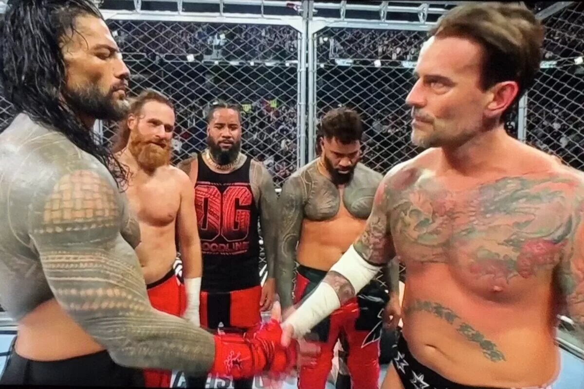 A photo of Roman Reigns and CM Punk shaking with The Usos and Sami Zayn at WWE Survivor Series 2024: WarGames.