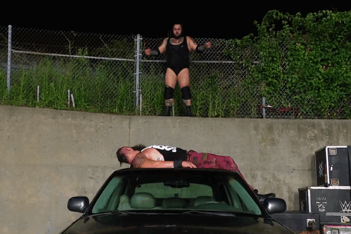 A photo of Brunson Reed about to hit the Tsunami on Braun Strowman on WWE Raw.