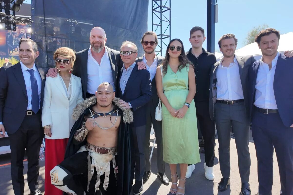 WWE official Triple H with the representatives Lucha Libre AAA Worldwide after their acquisition.