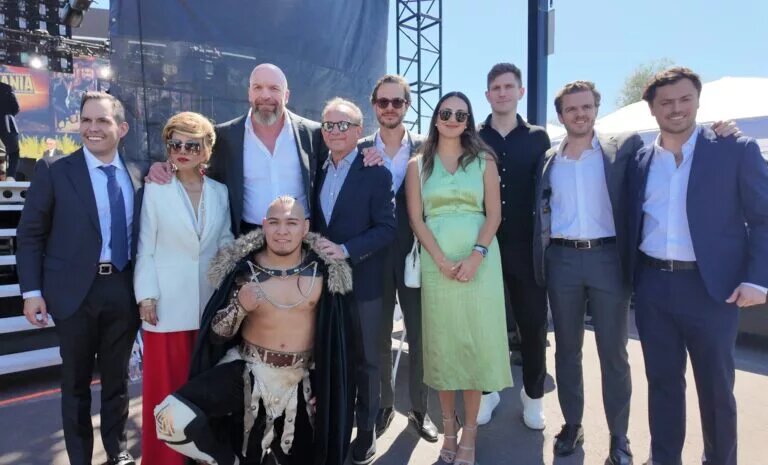 WWE official Triple H with the representatives Lucha Libre AAA Worldwide after their acquisition.