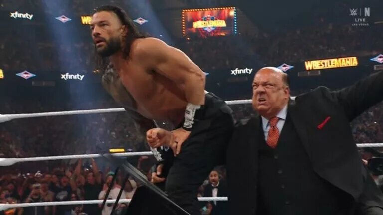 A photo of Paul Heyman giving Roman Reigns a low blow during his main event WWE WrestleMania 41 match against Seth Rollins and CM Punk.