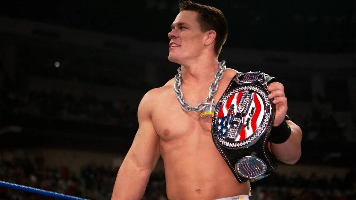 A graphic of John Cena wearing the United States CHampionship version of the Spinner belt