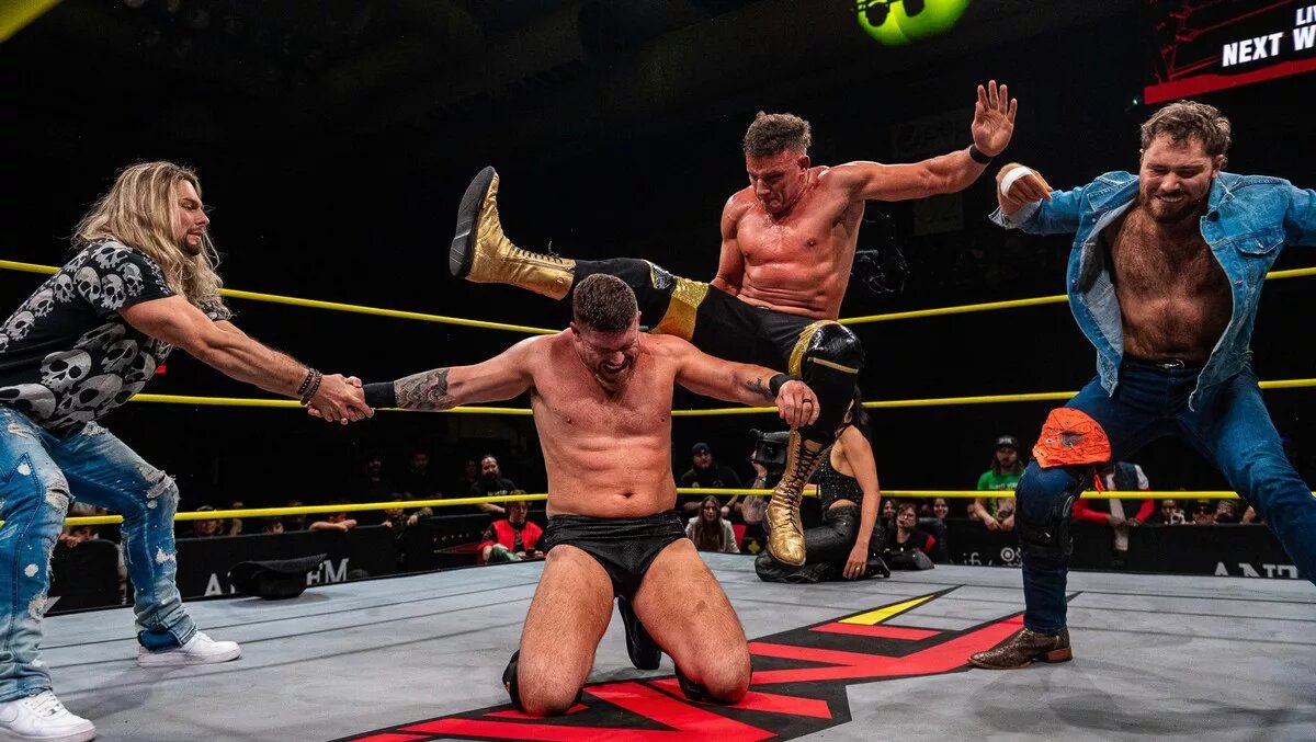 Steve Maclin swarmed by the NXT Outlaws, a graphic from the January 8 episode of TNA iMPACT