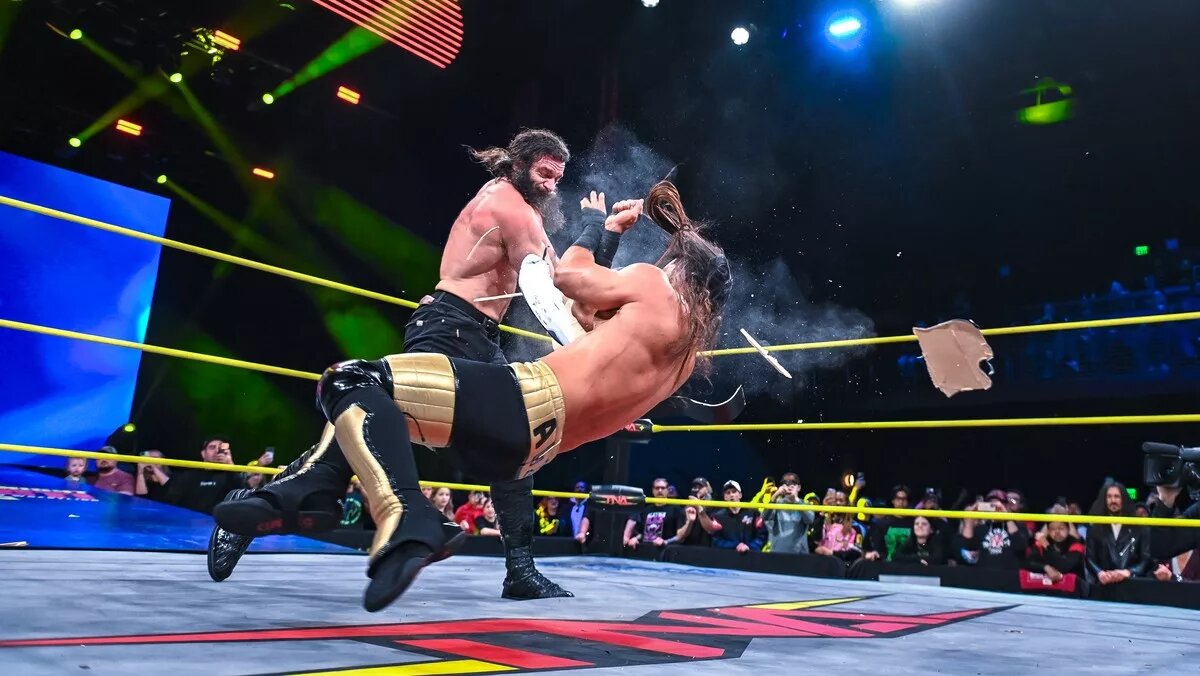 Elijah and Mustafa Ali in the Guitar Case Casket match on the February 19 episode of TNA Thursday Night iMPACT