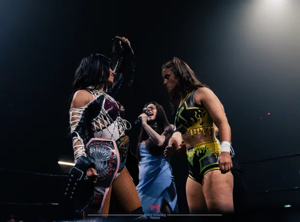 A photo of Francesca Oliver from a RevPro show announcing inside the ring before a title match.