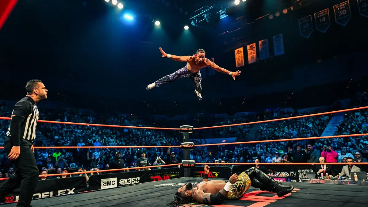 A graphic of Leon Slater flying at TNA Rebellion 2026 where he retained the X-Division Championship
