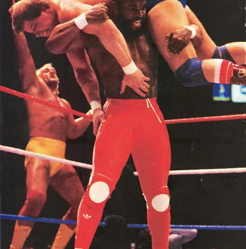 A photo of Mr. T hoisting up Roddy Piper at WWE WrestleMania 1 looking to slam him.