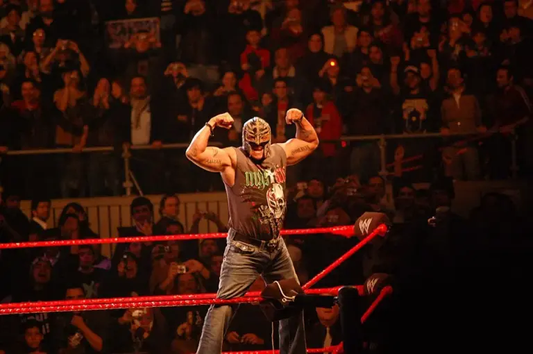 Image of Rey Mysterio on turnbuckle in WWE ring posing