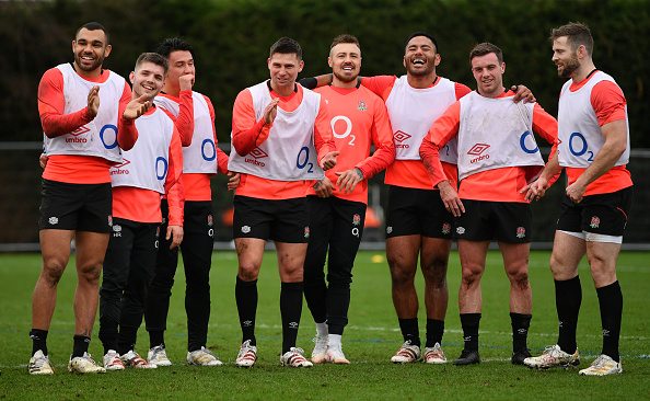 England's rugby team's back stands together during a training session in London, England
