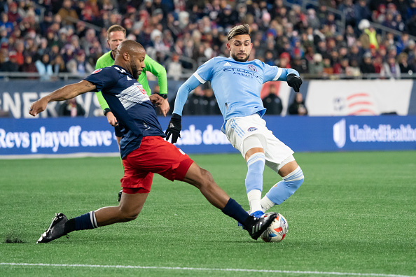 New England Revolution defender Andrew Farrell tackles Valentin Castellanos at the MLS Cup Playoffs