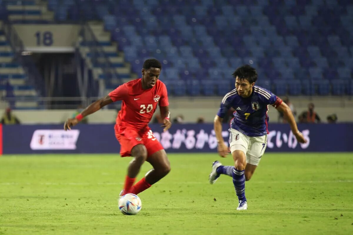 CanMNT forward Jonathan David with the ball as the CanMNT edges Japan at Al Maktoum Stadium