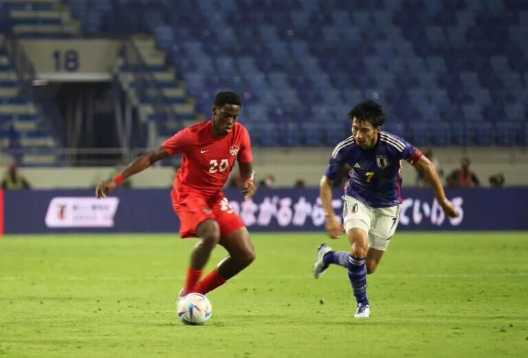 CanMNT forward Jonathan David with the ball as the CanMNT edges Japan at Al Maktoum Stadium