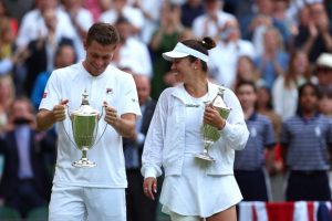 Neal Skupski and Desirae Krawczyk with their Wimbledon mixed doubles trophies.
