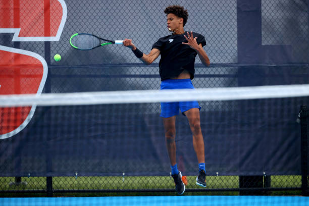 Gabriel Diallo of the Kentucky Wildcats hits a forehand against the Virginia Cavaliers during the Division I Men's Tennis Championship