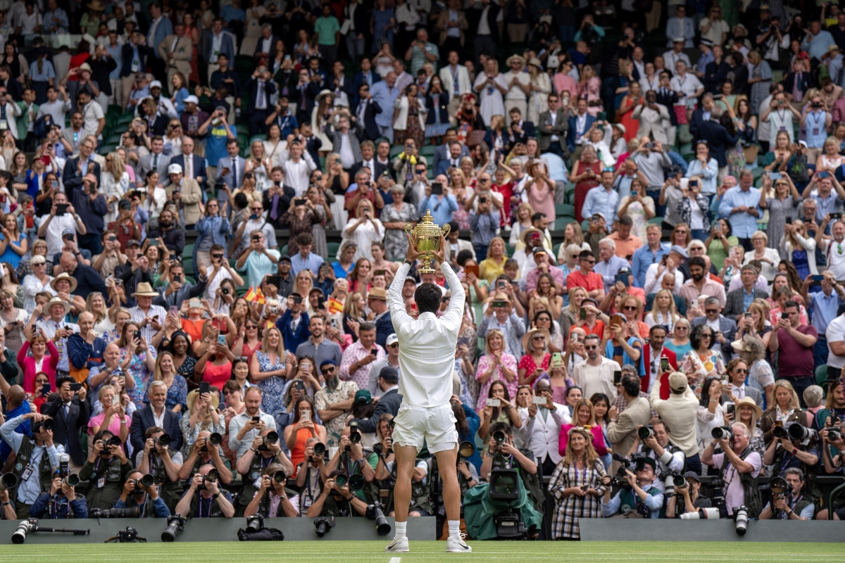 Carlos Alcaraz lifts the Wimbledon trophy.
