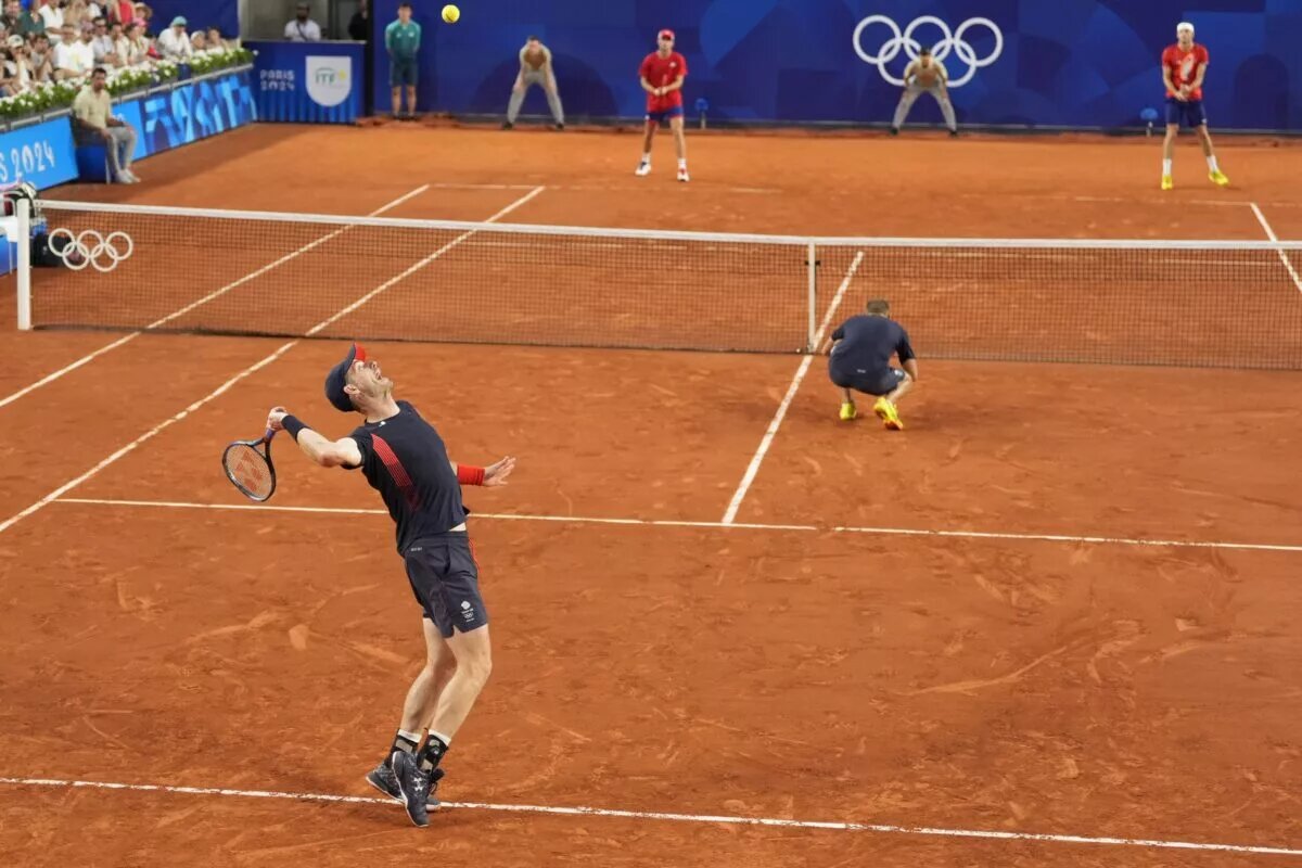 Andy Murray and Dan Evans in action for Great Britain.